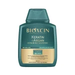 شامپو بیوکسین BIOXCIN مدل Dermocosmetic Laboratories حاوی روغن آرگان و کراتین حجم 300 میل